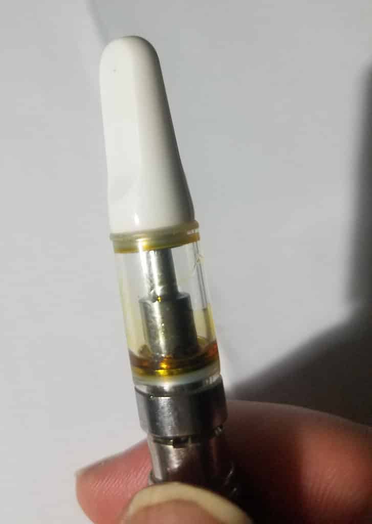 Nearly empty CO2 oil cartridge in vape pen.