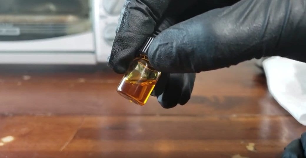 Decarbed shatter vial showing clear amber liquid