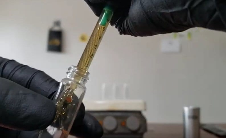 adding distillate to a vial